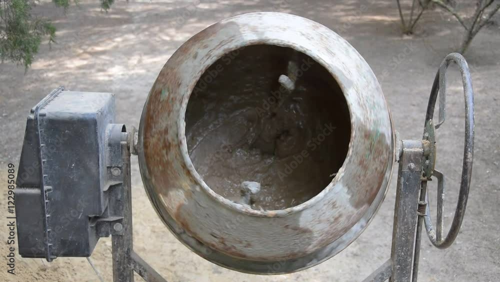 Concrete mixer turns on and mixes mortar. The concrete mixer is turned off. Front view. Close-up. Concrete mixer turns on and mixes mortar. The concrete mixer is turned off. Front view. Close-up.