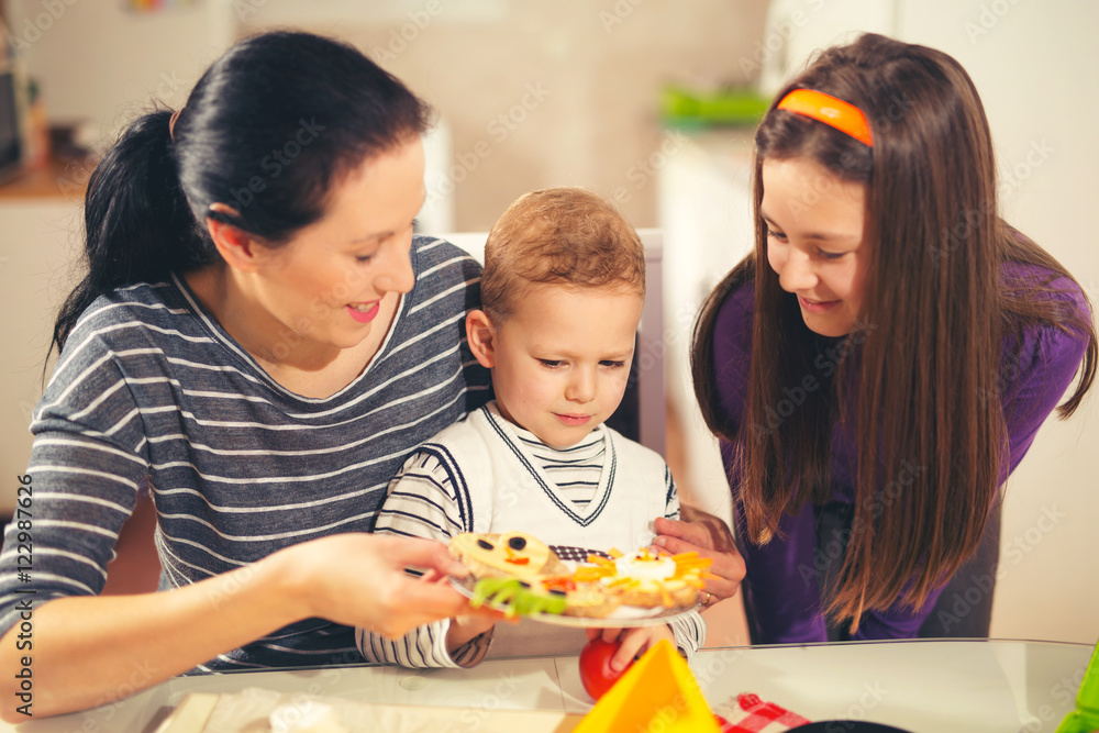 Mother making breakfast for her children in the morning Mother making breakfast for her children in the morning