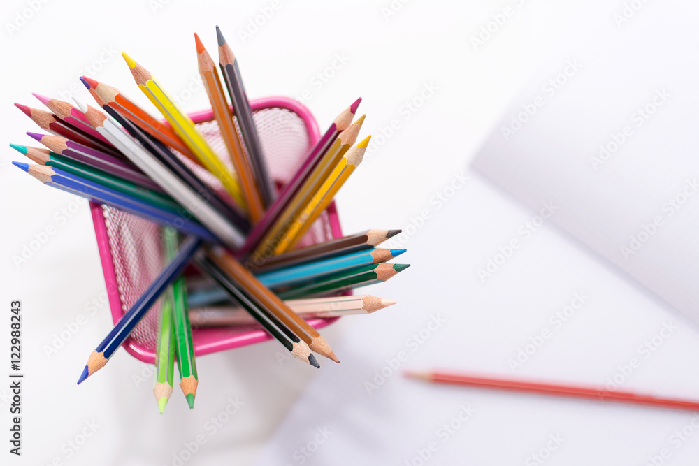 colored pencils and copybook blurred