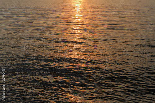 The rays of the setting sun playing on the water surface