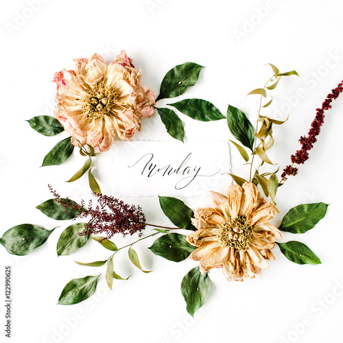 calligraphy word monday and round frame wreath pattern, beige dried peonies flowers, branches and leaves isolated on white background. flat lay, top view, mock up