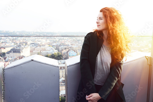 Red-haired girl on the top of Lviv city hall