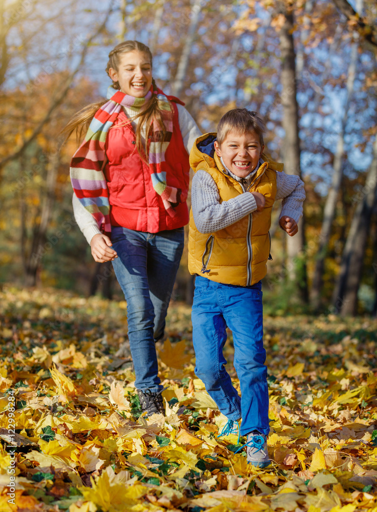 Fototapeta premium Kids having fun in autumn park