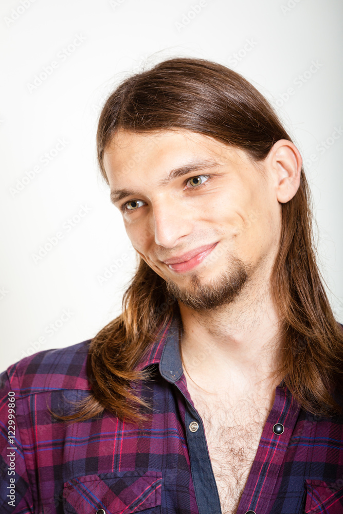 Smiling guy with long hairs.