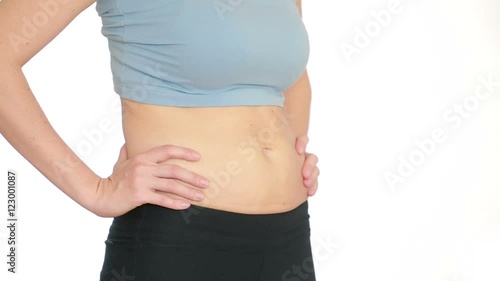 Woman fat belly. vacuum massage of the abdomen. girl pulls the stomach photo