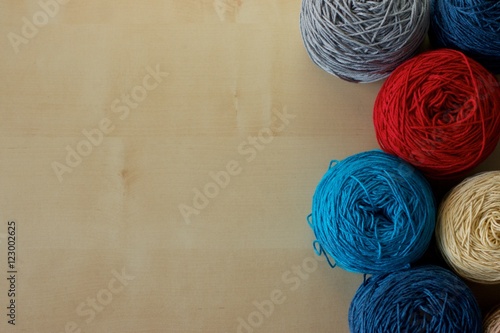 Balls of wool cotton silk yarn set on copy space wood background on left