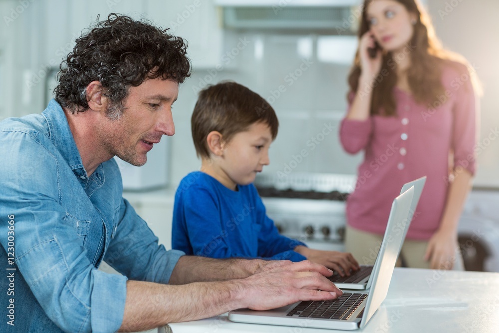Father and son using laptop Father and son using laptop