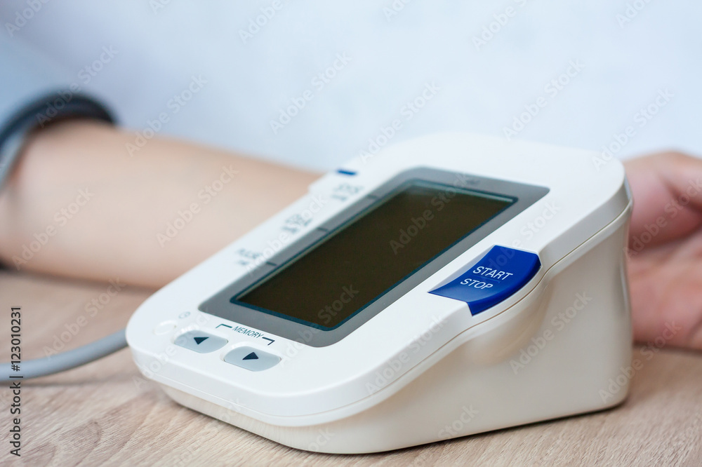 Woman using digital blood pressure monitor Woman using digital blood pressure monitor
