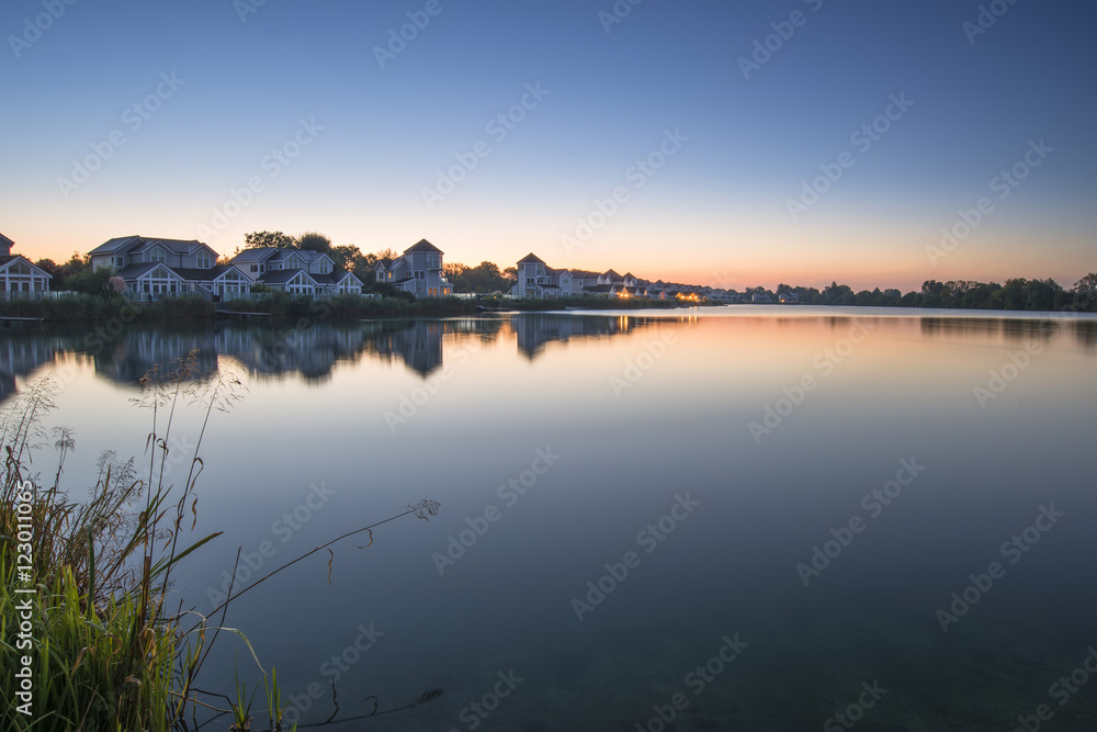 Stunning dawn landscape image of clear sky over calm lake