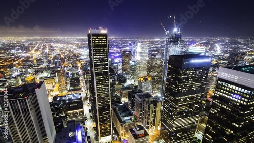 Time lapse overview with tilt down motion of city lights in downtown Los Angeles at twilight