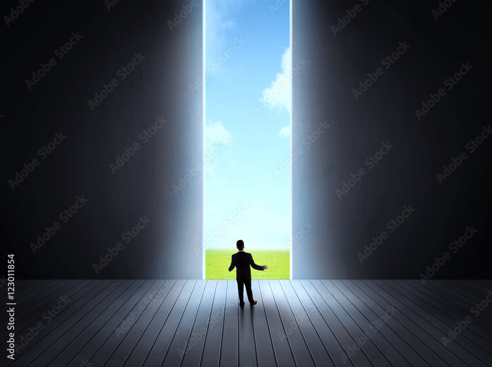 businessman walking to open gate businessman walking to open gate
