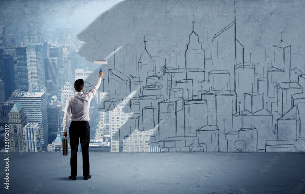 Elegant salesman repainting the city on wall Elegant salesman repainting the city on wall