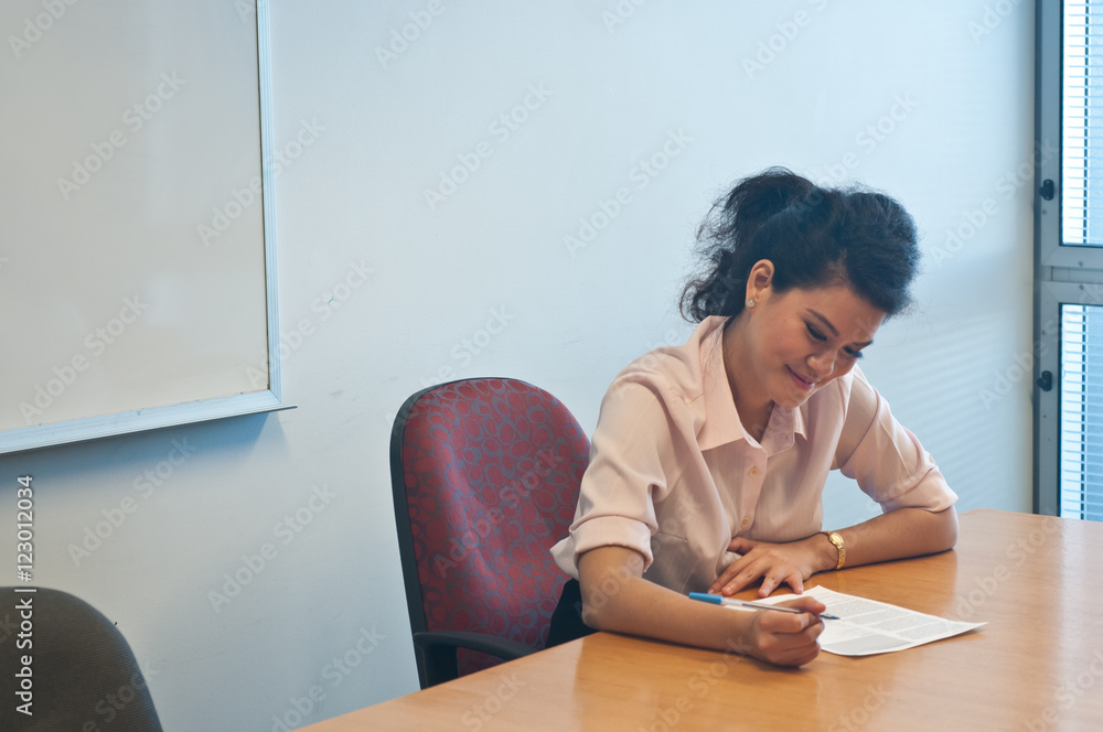 Business woman examining contract agreement in office Business woman examining contract agreement in office
