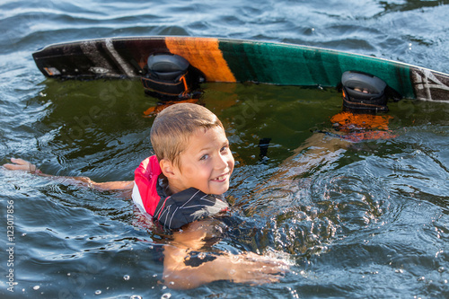 Bild auf Leinwand Young Boy learning to Wakeboard
