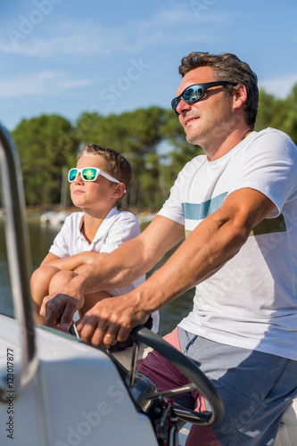 family enjoying a summer day on a boat © eric