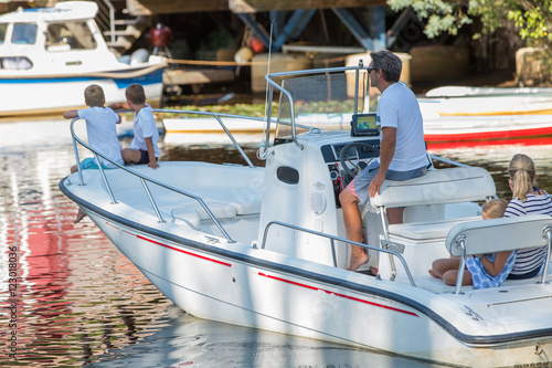 family hanging out together in a boat