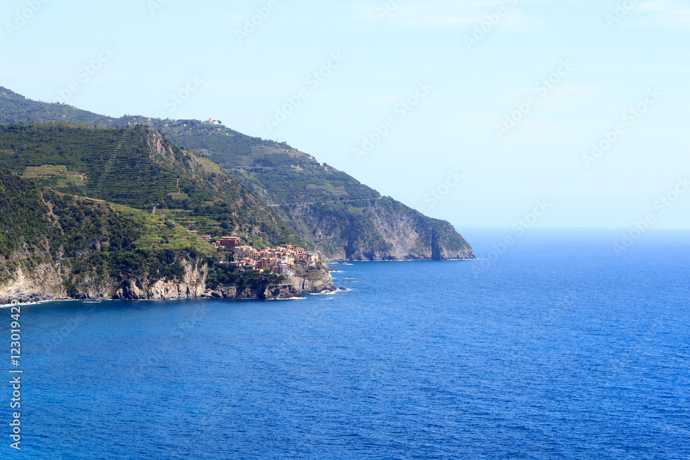 Rocky coast and Cinque Terre village Manarola and Mediterranean Sea, Italy