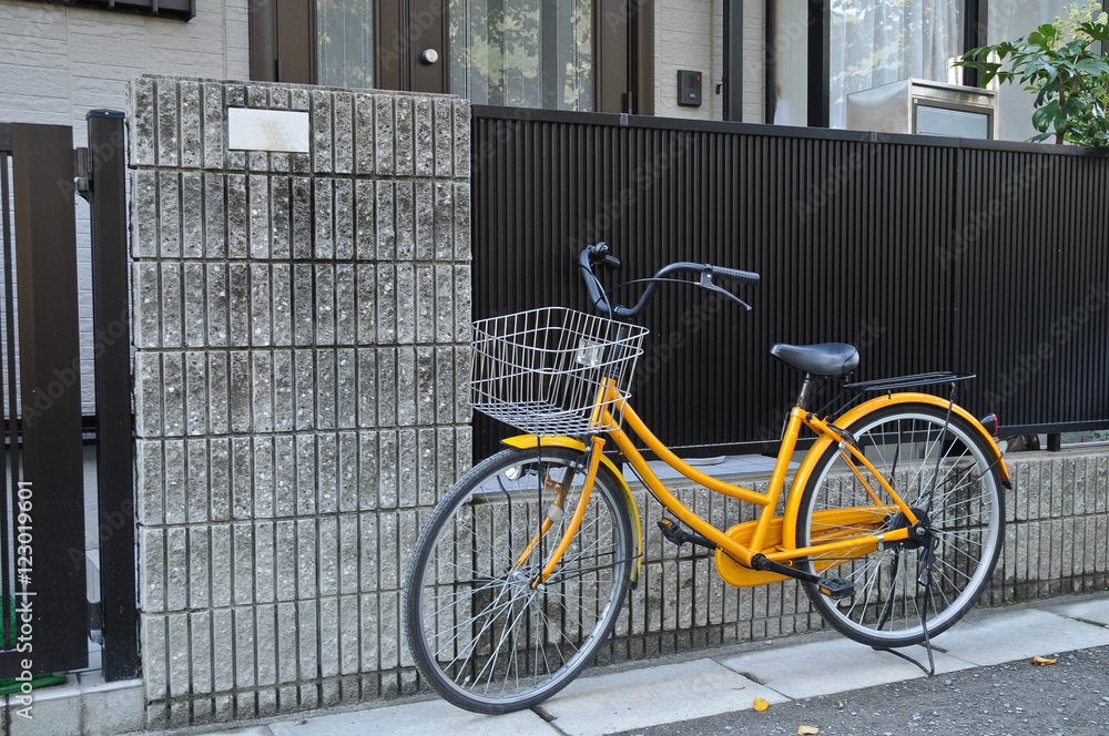 Yellow classical bicycle parked on the street Yellow classical bicycle parked on the street