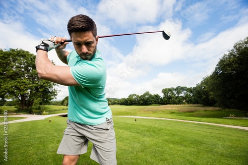 Focused man playing golf