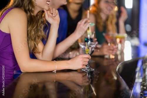 Woman having glass of cocktail in bar