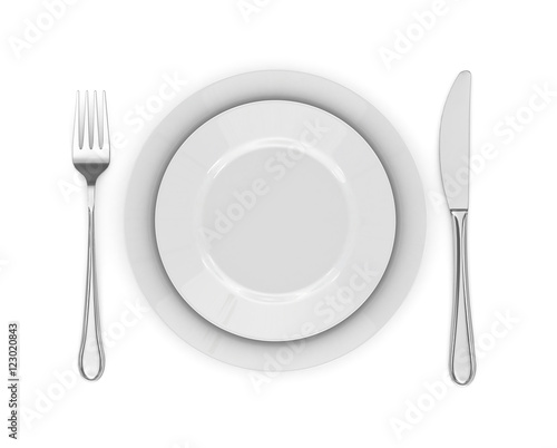 Dinner place setting. A white plate with silver fork and spoon i