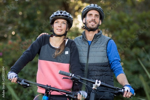 Fototapeta Naklejka Na Ścianę i Meble -  Biker couple standing with mountain bike