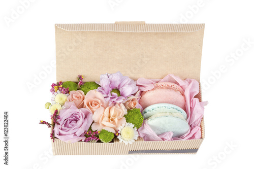 Colorful macaroons in a paper box on white background