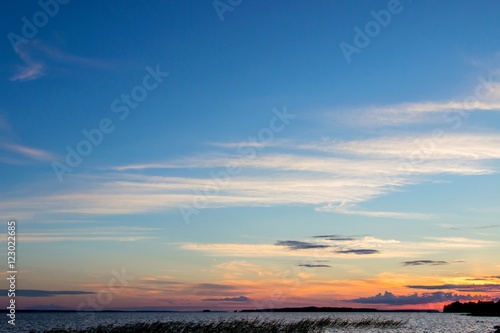 Beautiful tranquil summer sunset on the Onega lake, Karelia, Russia © azamotkin