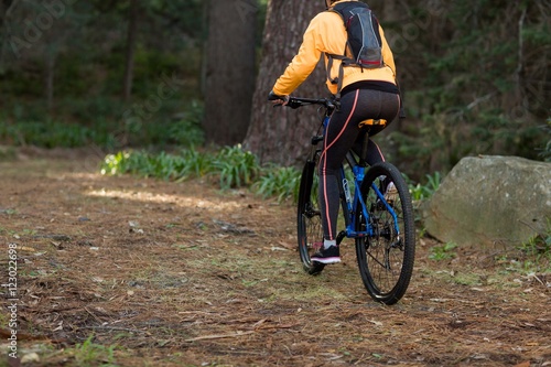 Female biker cycling in countryside