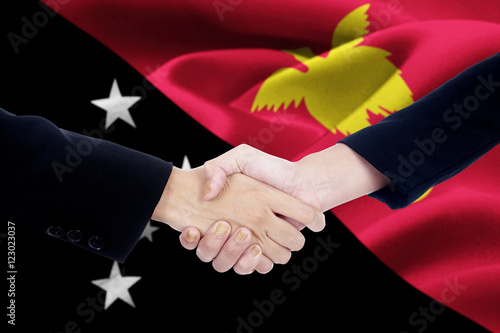 Handshake with flag of Papua New Guinea