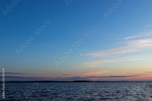 Beautiful tranquil summer sunset on the Onega lake, Karelia, Russia