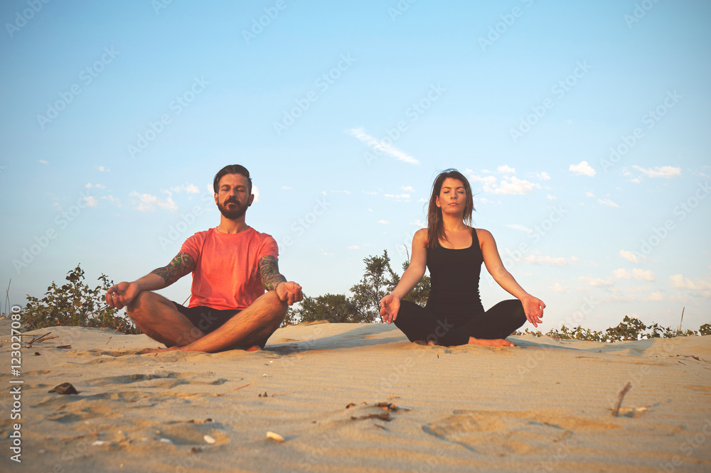 Woman and man practicing yoga in various poses (asana)