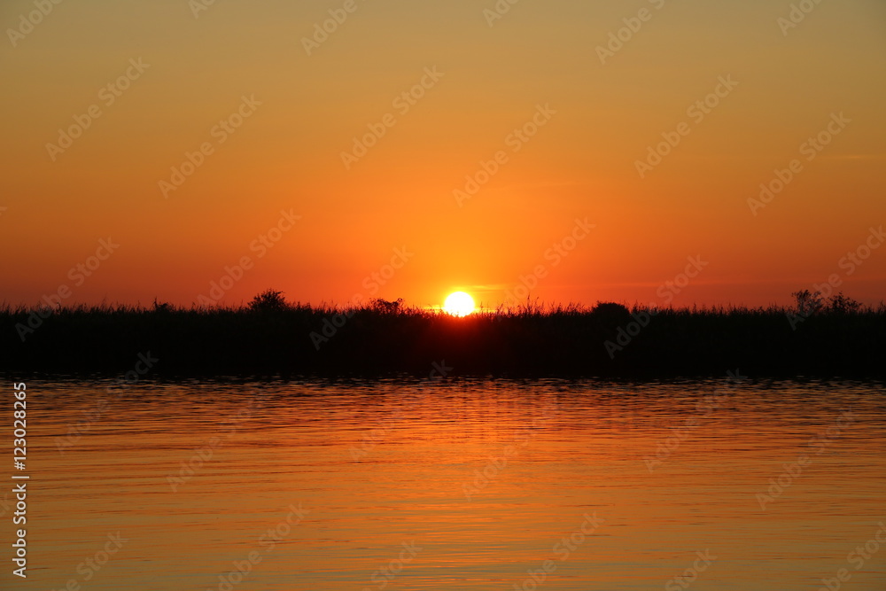 Romantic sunset at Cuando River in Botswana, Africa 