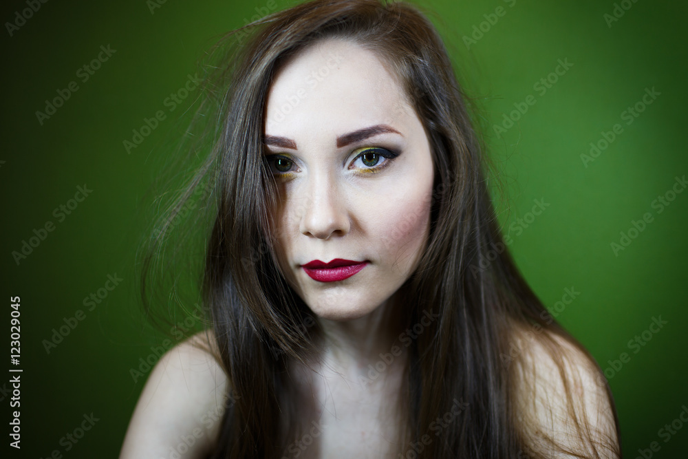 Portrait of a beautiful young girl on a dark green background Portrait of a beautiful young girl on a dark green background