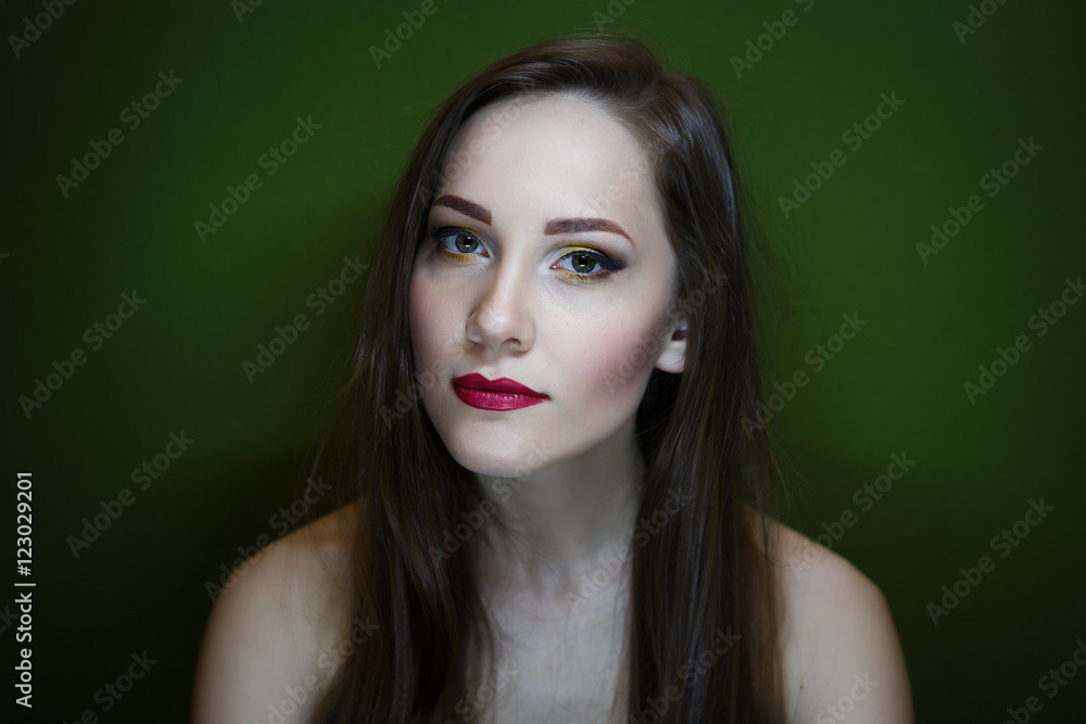 Portrait of a beautiful young girl on a dark green background Portrait of a beautiful young girl on a dark green background