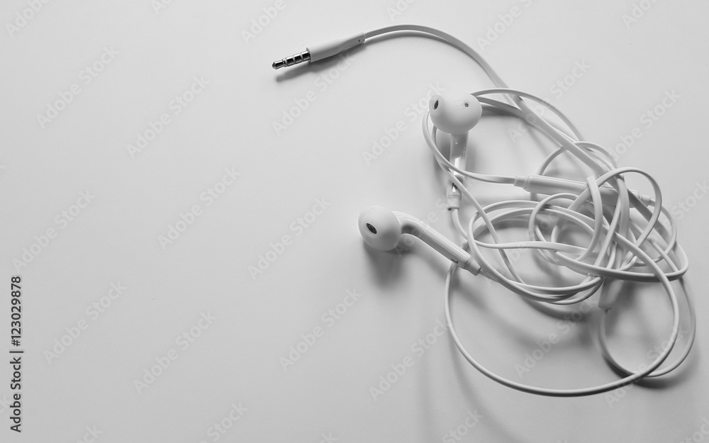 Tangled headphone cable on white background isolated. Tangled headphone cable on white background isolated.