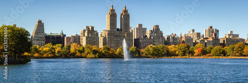 Central Park and Manhattan Upper West Side with colorful Fall foliage and a panoramic view across Jacqueline Kennedy Onassis Reservoir with its fountain. Central Park West in autumn. New York City