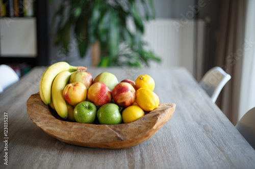Wooden fruit basket on table