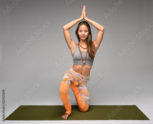 Practicing yoga in horse pose photo