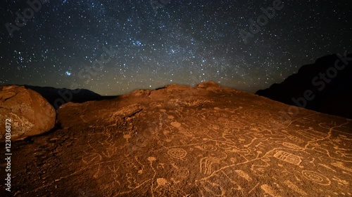 Astrophotography Time Lapse with tilt up motion of starry sky over Native American petroglyphs in Eastern Sierra, California photo