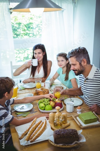 Happy family having breakfast together