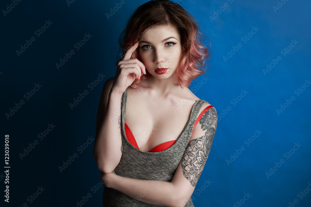 Portrait of a beautiful young girl with tattoo in the Studio Portrait of a beautiful young girl with tattoo in the Studio