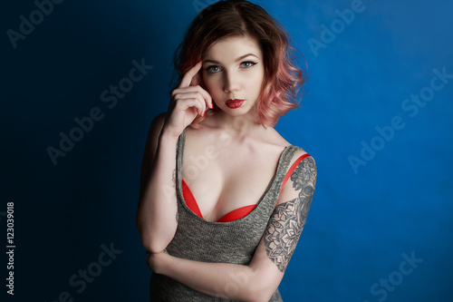 Portrait of a beautiful young girl with tattoo in the Studio