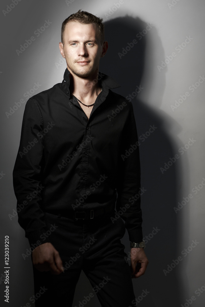 Portrait of handsome man in Studio wearing a black shirt Portrait of handsome man in Studio wearing a black shirt