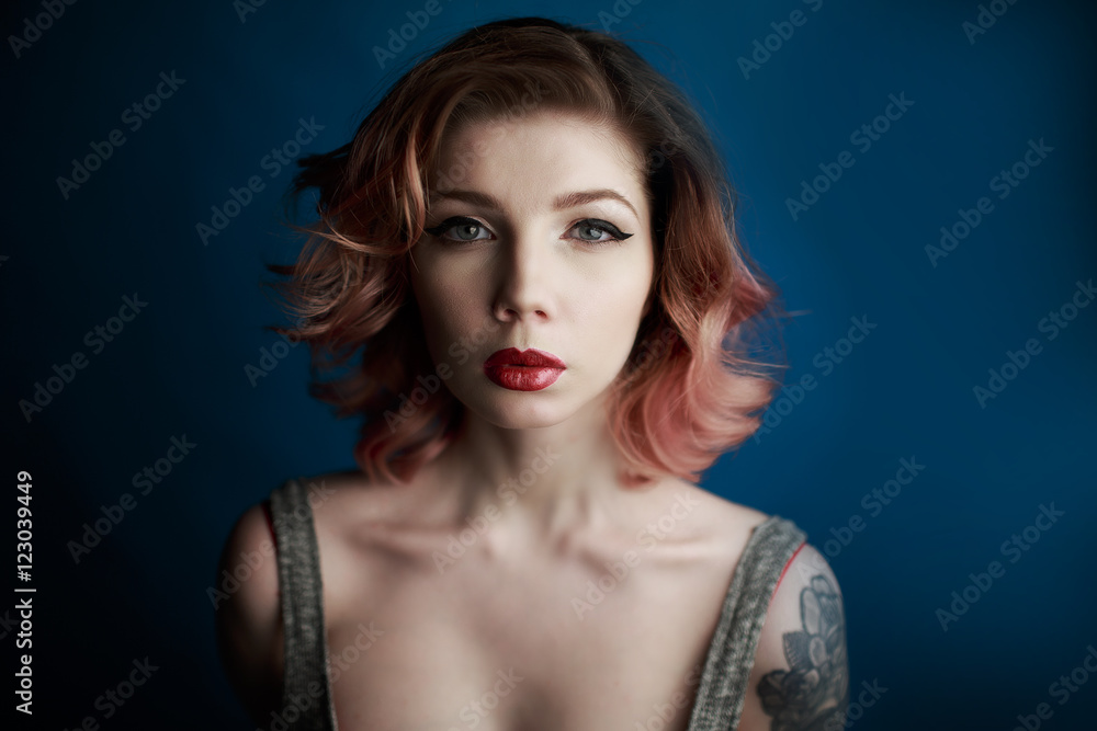 Portrait of a beautiful young girl with tattoo in the Studio Portrait of a beautiful young girl with tattoo in the Studio