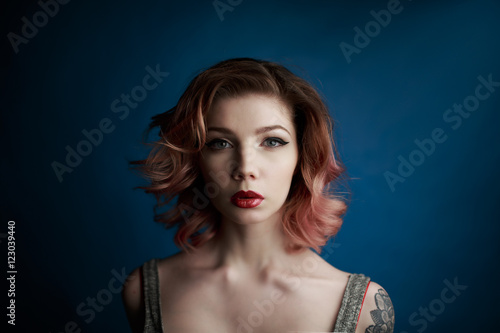 Portrait of a beautiful young girl with tattoo in the Studio