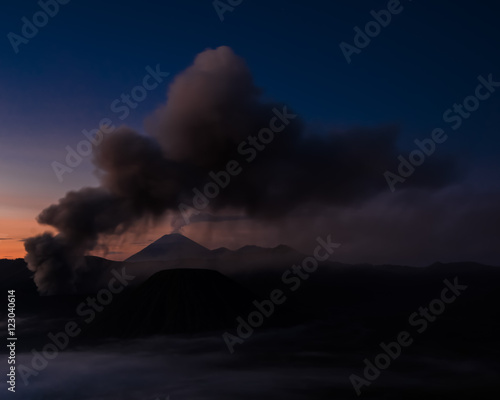 Smoke and ash from the volcano hovering over the water (Bohorok, Indonesia)