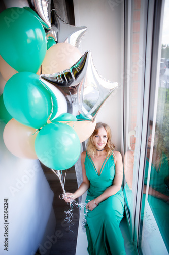 Portrait of a beautiful woman in a green dress