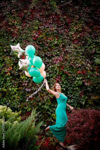Portrait of a beautiful woman in a green dress