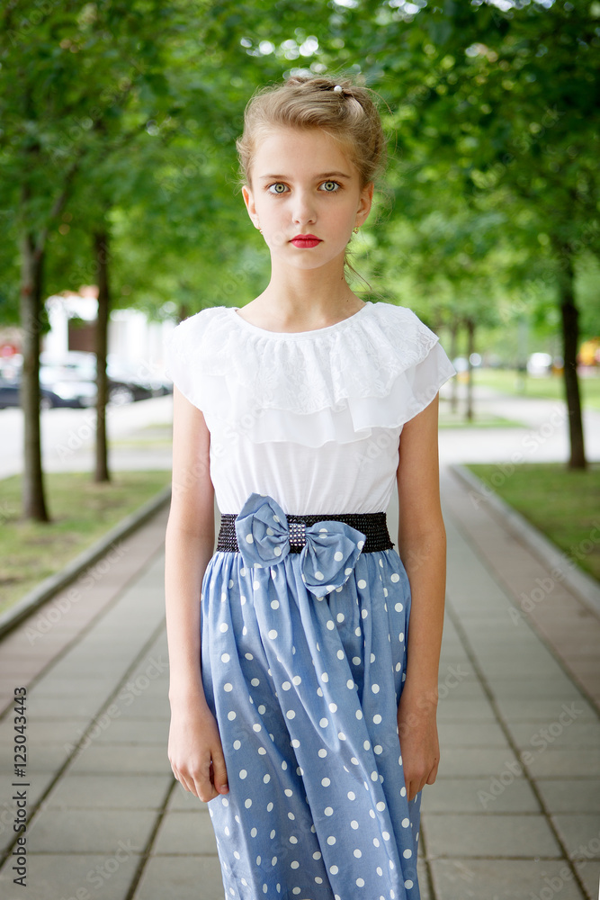 Portrait of a beautiful young girl in the Park skirt blouse nature fashion style Portrait of a beautiful young girl in the Park skirt blouse nature fashion style